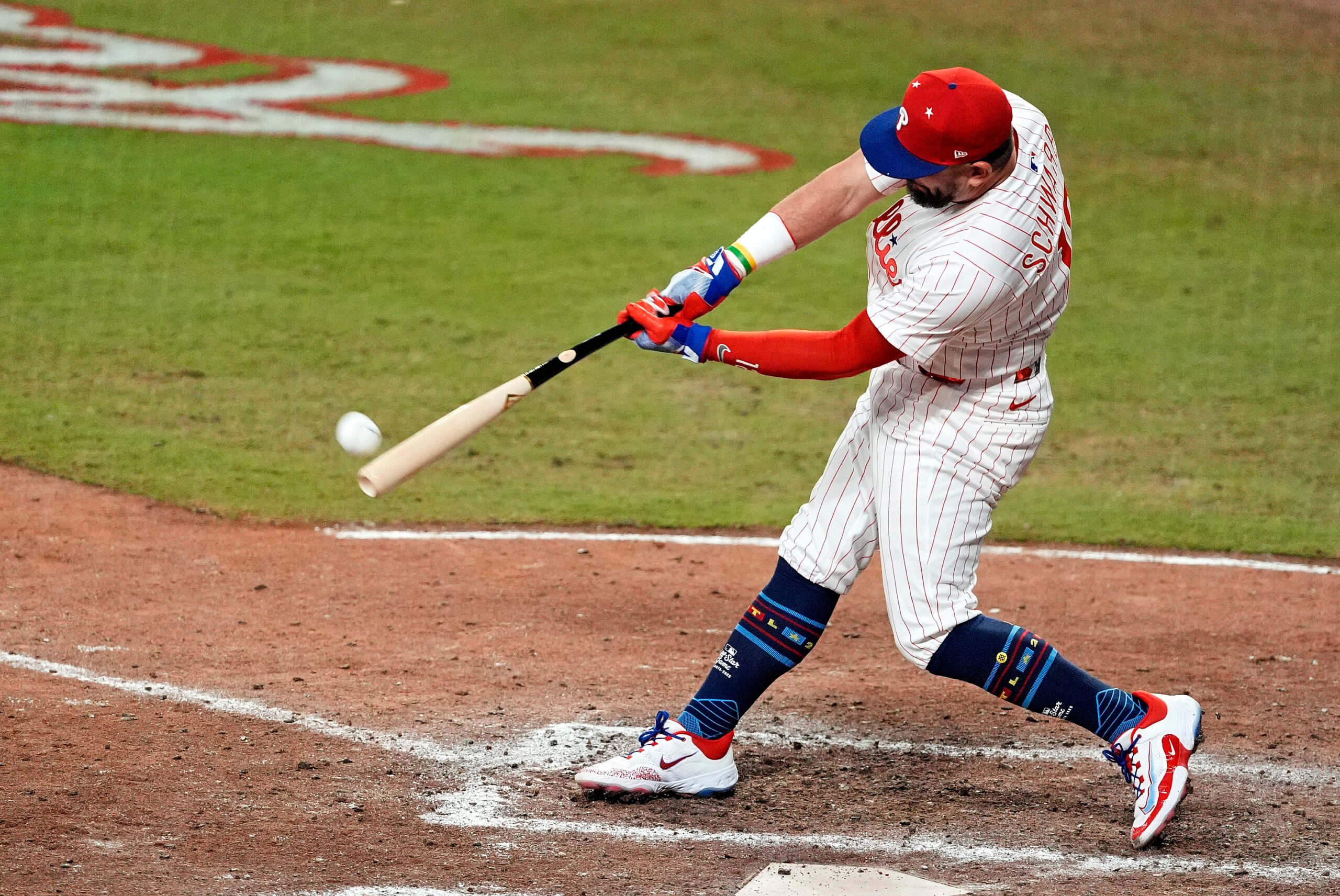 Jul 15, 2025; Cumberland, Georgia, USA; National League designated hitter Kyle Schwarber (12) of the Philadelphia Phillies hits a home run in the swing off of after the  2025 MLB All Star Game ended in a tie at Truist Park. Mandatory Credit: Dale Zanine-Imagn Images
