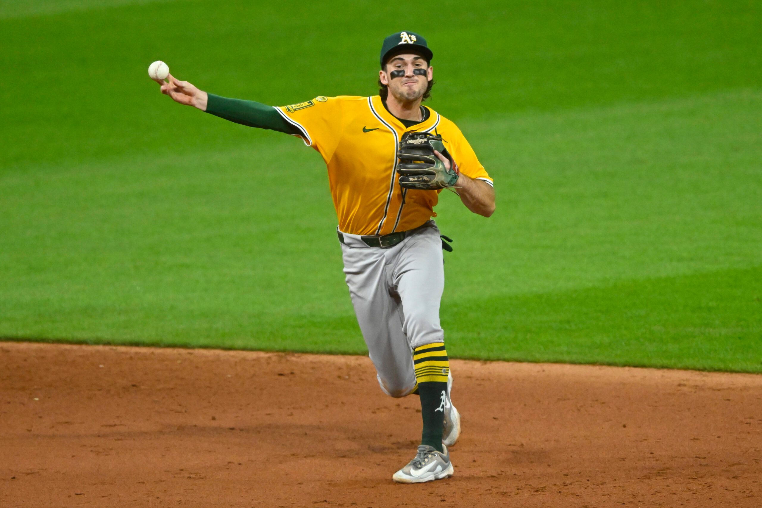 Jul 19, 2025; Cleveland, Ohio, USA; Athletics shortstop Jacob Wilson (5) throws to first base in the sixth inning against the Cleveland Guardians at Progressive Field. Mandatory Credit: David Richard-Imagn Images