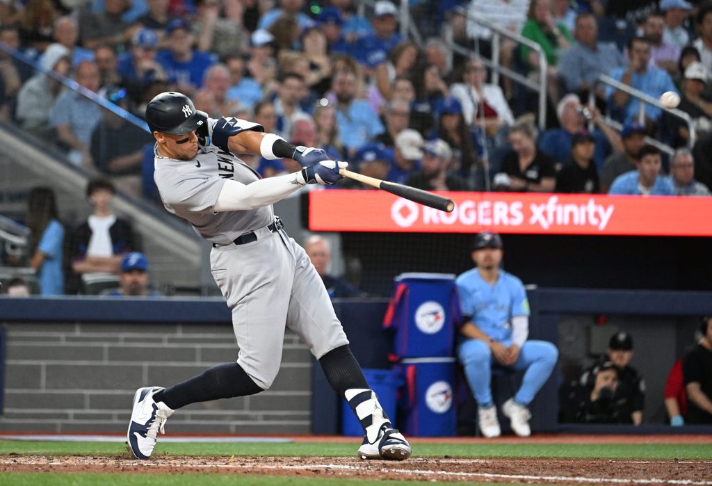 Jul 23, 2025; Toronto, Ontario, CAN; New York Yankees designated hitter Aaron Judge (99) hits a two run home run against the Toronto Blue Jays in the sixth inning at Rogers Centre. Mandatory Credit: Dan Hamilton-Imagn Images