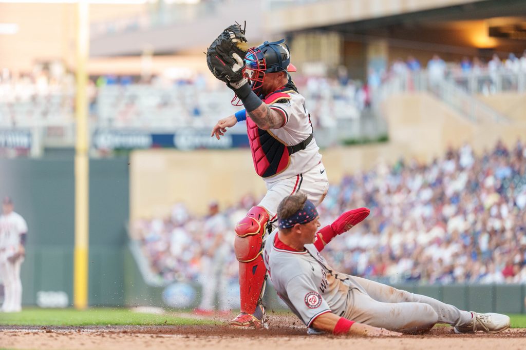 Jul 26, 2025; Minneapolis, Minnesota, USA; Washington Nationals outfielder Alex Call (17) scores on a hit by shortstop CJ Abrams (5) off Minnesota Twins starting pitcher Joe Ryan (41) in the fifth inning at Target Field. Mandatory Credit: Matt Blewett-Imagn Images