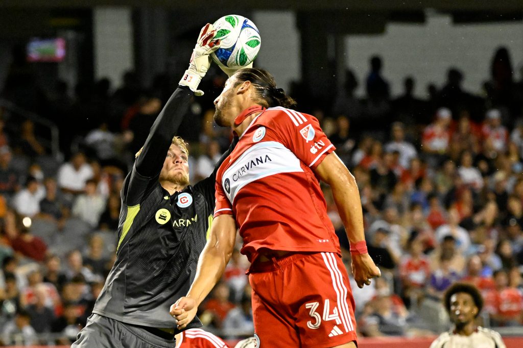 Jul 26, 2025; Chicago, Illinois, USA; Chicago Fire goalkeeper Chris Brady (1) and defender Omar González (34) defend against the New York Red Bulls during the second half at Soldier Field. Mandatory Credit: Matt Marton-Imagn Images