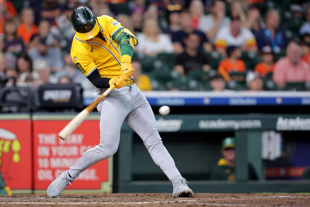 Jul 27, 2025; Houston, Texas, USA; Athletics left fielder Brent Rooker (25) hits a single against the Houston Astros during the fourth inning at Daikin Park. Mandatory Credit: Erik Williams-Imagn Images