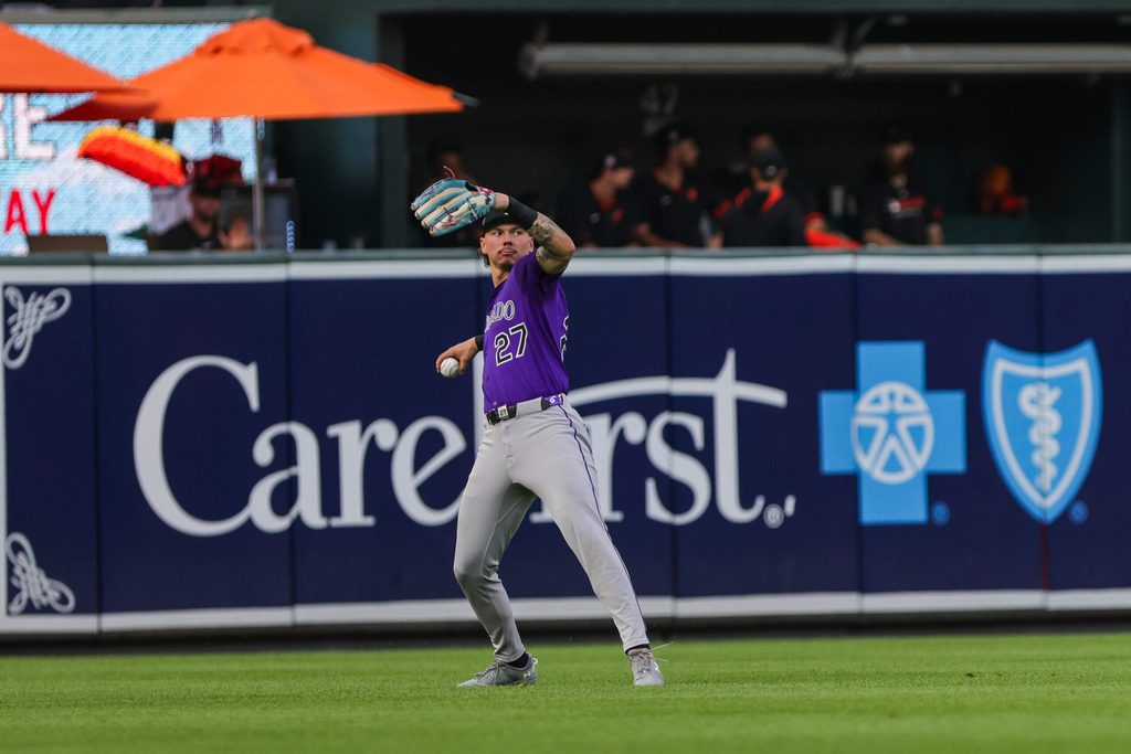 Jul 26, 2025; Baltimore, Maryland, USA; Colorado Rockies left fielder Jordan Beck (27) throws the ball back into the infield against the Baltimore Orioles in the second inning at Oriole Park at Camden Yards. Mandatory Credit: Lexi Thompson-Imagn Images