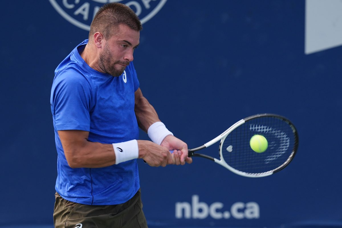 Jul 28, 2025; Toronto, ON, Canada; Borna Coric (CRO) hits a ball to Matteo Gigante (not pictured) during first round play at Sobeys Stadium. Mandatory Credit: John E. Sokolowski-Imagn Images