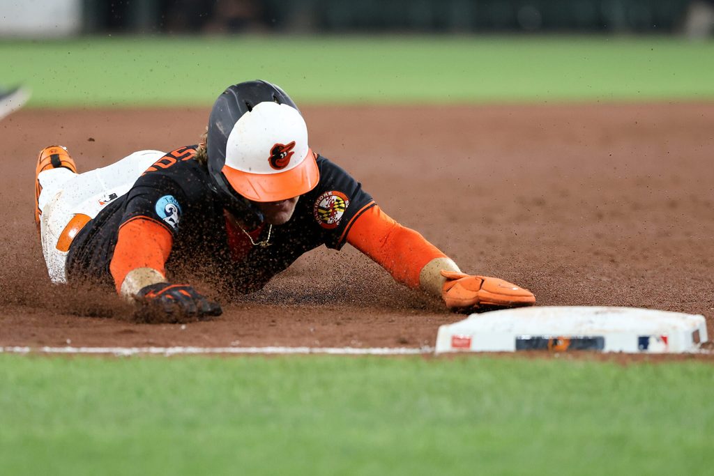 Jul 28, 2025; Baltimore, Maryland, USA; Baltimore Orioles shortstop Gunnar Henderson (2) slides into third base safely during the sixth inning against the Toronto Blue Jays at Oriole Park at Camden Yards. Mandatory Credit: Daniel Kucin Jr.-Imagn Images