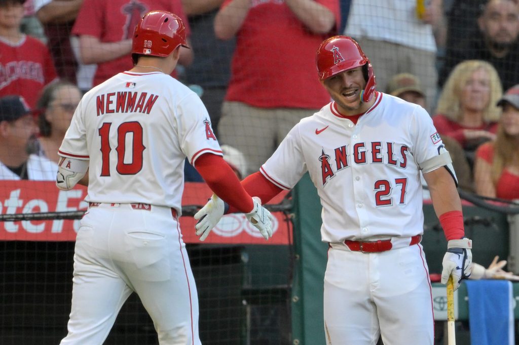 Jul 28, 2025; Anaheim, California, USA; Los Angeles Angels third baseman Kevin Newman (10) is congratulated by designated hitter Mike Trout (27) after hitting a two-run home run during the third inning against the Texas Rangers at Angel Stadium. Mandatory Credit: Jayne Kamin-Oncea-Imagn Images