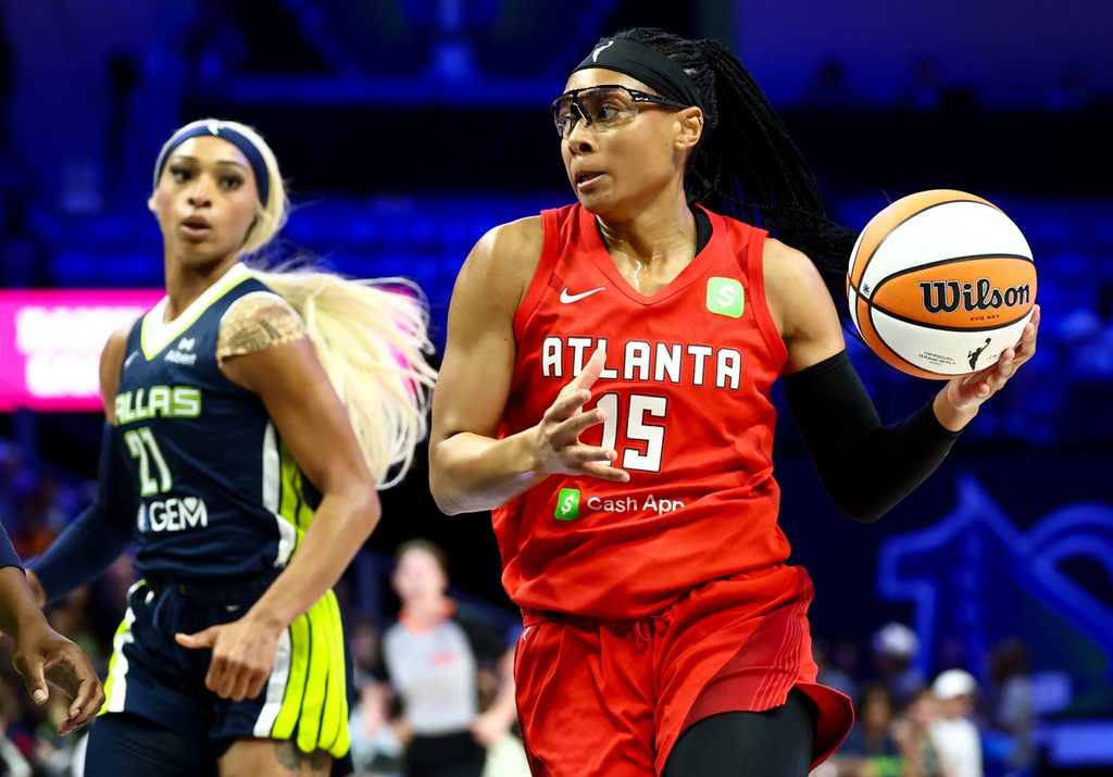 Jul 30, 2025; Arlington, Texas, USA; Atlanta Dream guard Allisha Gray (15) drives to the basket past Dallas Wings guard DiJonai Carrington (21) during the first half at College Park Center. Mandatory Credit: Kevin Jairaj-Imagn Images