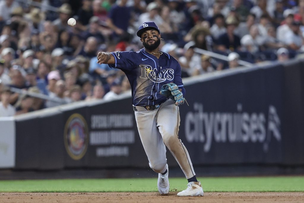 Jul 30, 2025; Bronx, New York, USA; Tampa Bay Rays third baseman Junior Caminero (13) throws a runner out at first base in the sixth inning against the New York Yankees at Yankee Stadium. Mandatory Credit: Wendell Cruz-Imagn Images