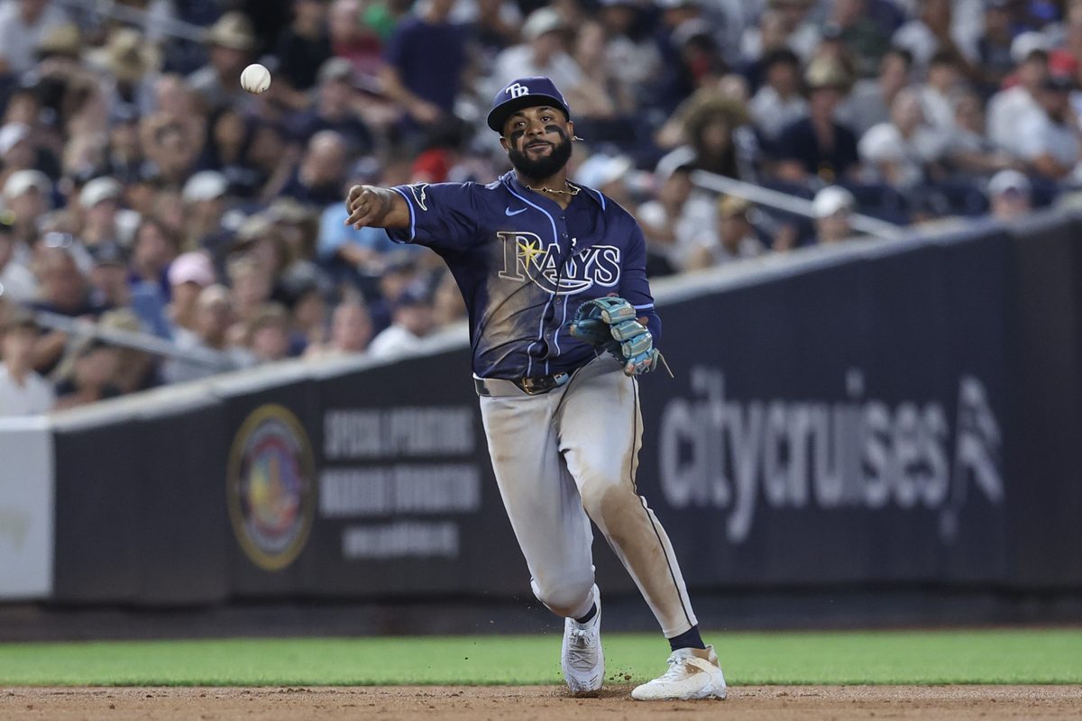 Jul 30, 2025; Bronx, New York, USA; Tampa Bay Rays third baseman Junior Caminero (13) throws a runner out at first base in the sixth inning against the New York Yankees at Yankee Stadium. Mandatory Credit: Wendell Cruz-Imagn Images