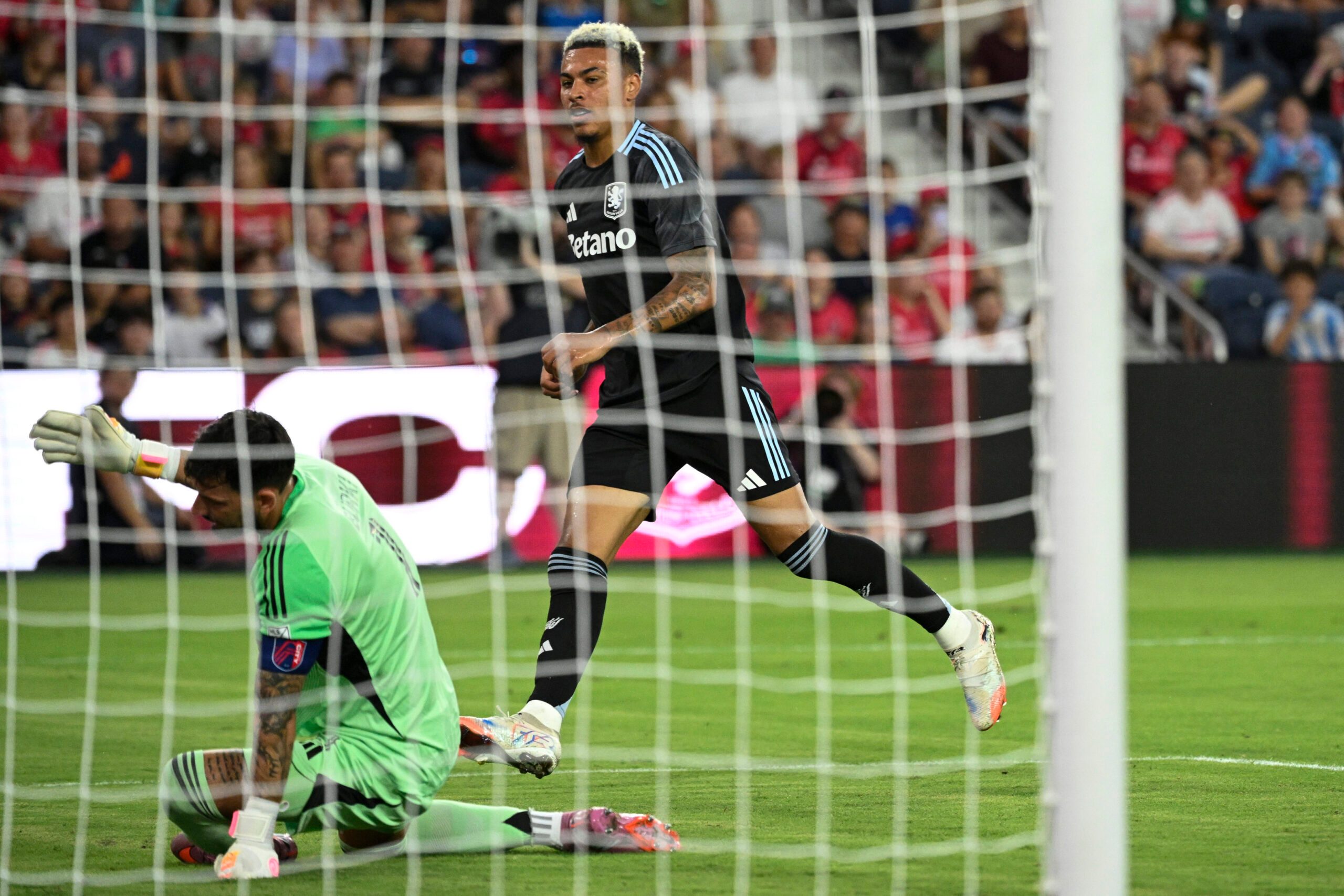 Jul 30, 2025; St. Louis, Missouri, USA; Aston Villa midfielder Morgan Rogers (27) watches the ball go past St. Louis City goalkeeper Roman Burki (1) for a goal in the first half at Energizer Park. Mandatory Credit: Joe Puetz-Imagn Images