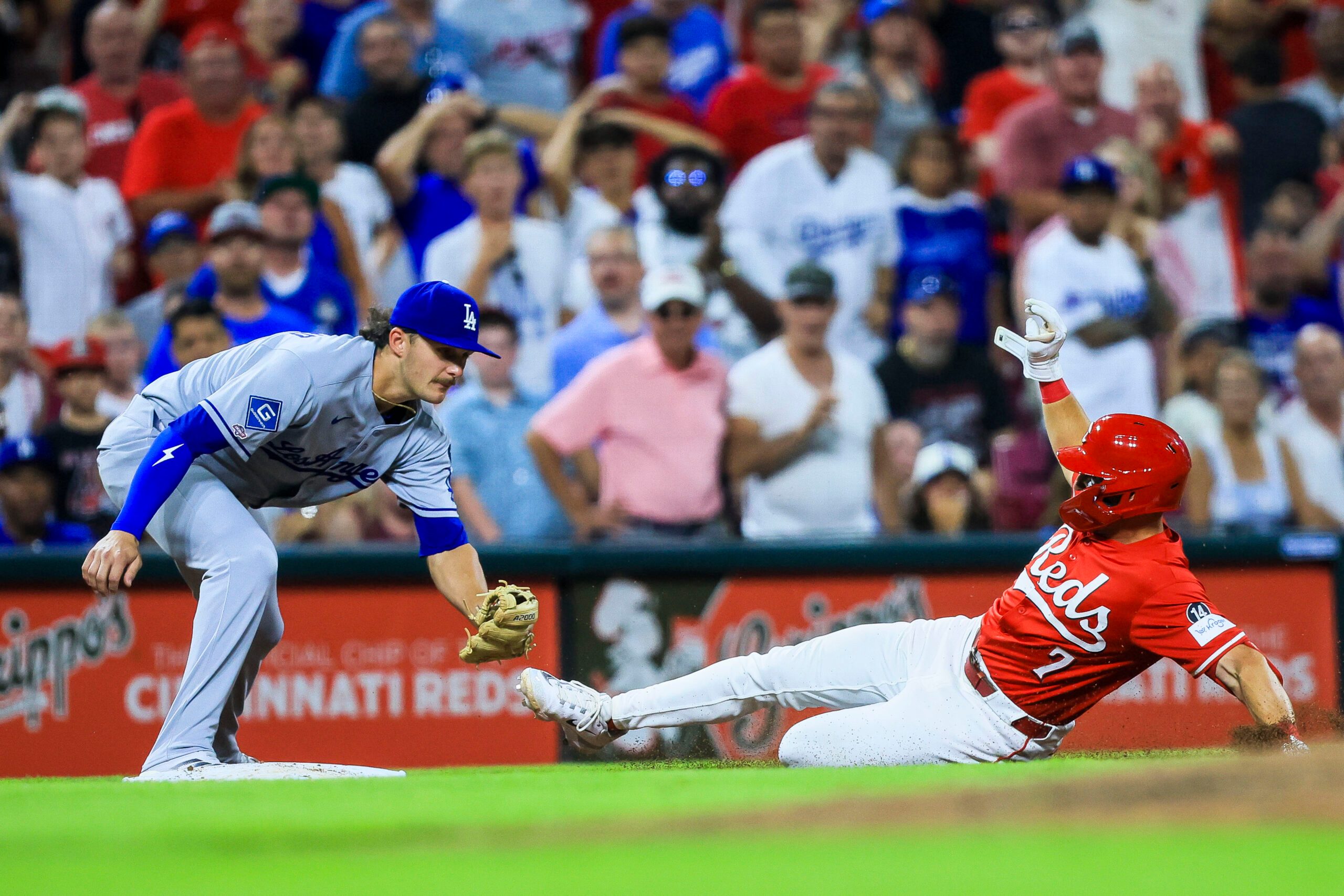 Jul 30, 2025; Cincinnati, Ohio, USA; Cincinnati Reds first baseman Spencer Steer (7) slides into third after hitting a two-run triple in the eighth inning against the Los Angeles Dodgers at Great American Ball Park. Mandatory Credit: Katie Stratman-Imagn Images