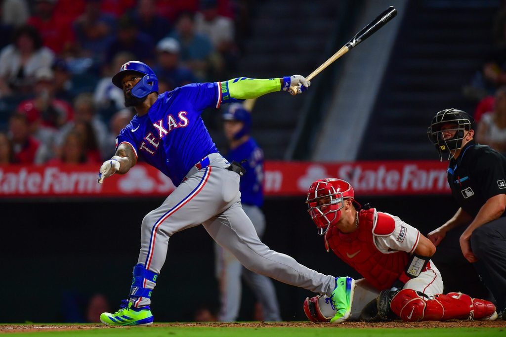 Jul 30, 2025; Anaheim, California, USA; Texas Rangers right fielder Adolis García (53) hits a two run home run against the Los Angeles Angels during the eighth inning at Angel Stadium. Mandatory Credit: Gary A. Vasquez-Imagn Images