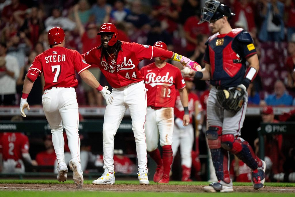 Cincinnati Reds shortstop Elly De La Cruz (44) high fives Cincinnati Reds first baseman Spencer Steer (7) after he hit a 3-run home in the eighth inning between Cincinnati Reds and Atlanta Braves at Great American Ball Park in Cincinnati on July 30, 2025.