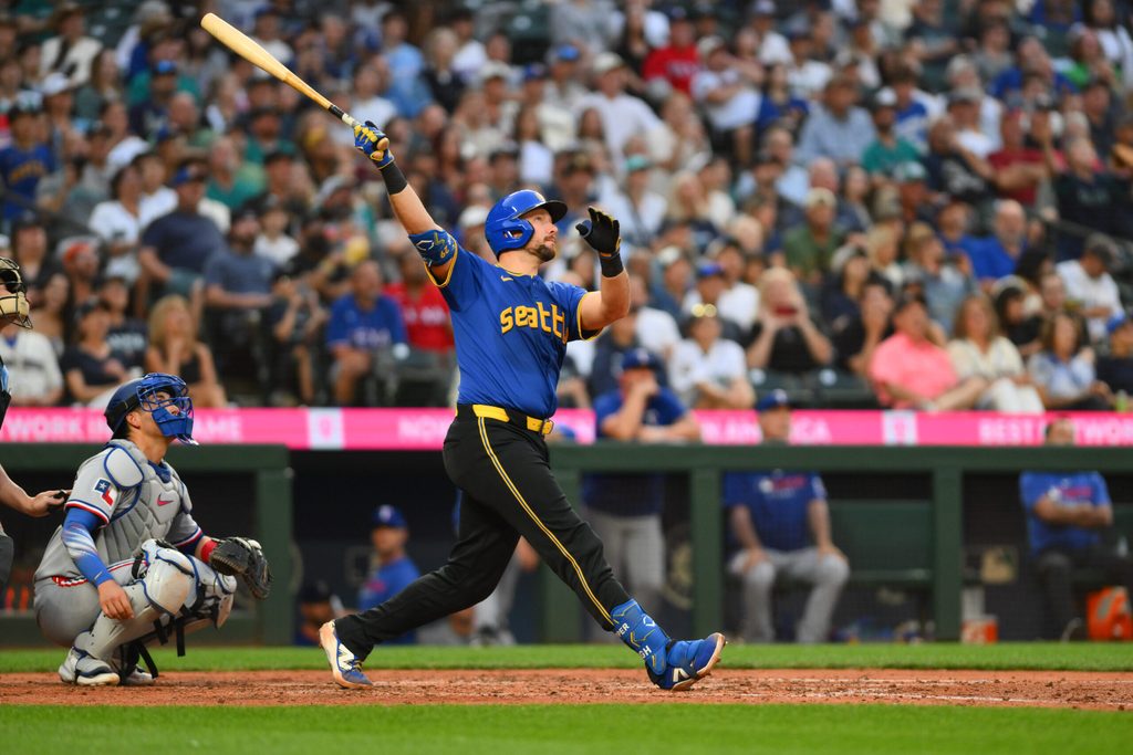 Jul 31, 2025; Seattle, Washington, USA; Seattle Mariners catcher Cal Raleigh (29) hits a home run against the Texas Rangers during the fifth inning at T-Mobile Park. Mandatory Credit: Steven Bisig-Imagn Images