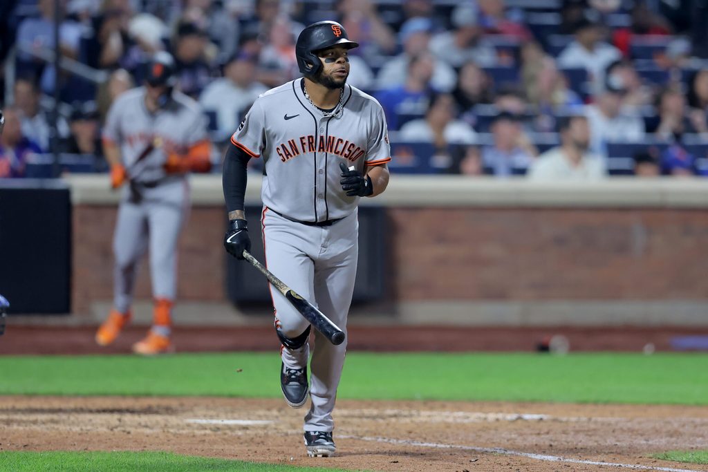 Aug 1, 2025; New York City, New York, USA; San Francisco Giants pinch hitter Dominic Smith (7) watches his RBI single against the New York Mets during the tenth inning at Citi Field. Mandatory Credit: Brad Penner-Imagn Images