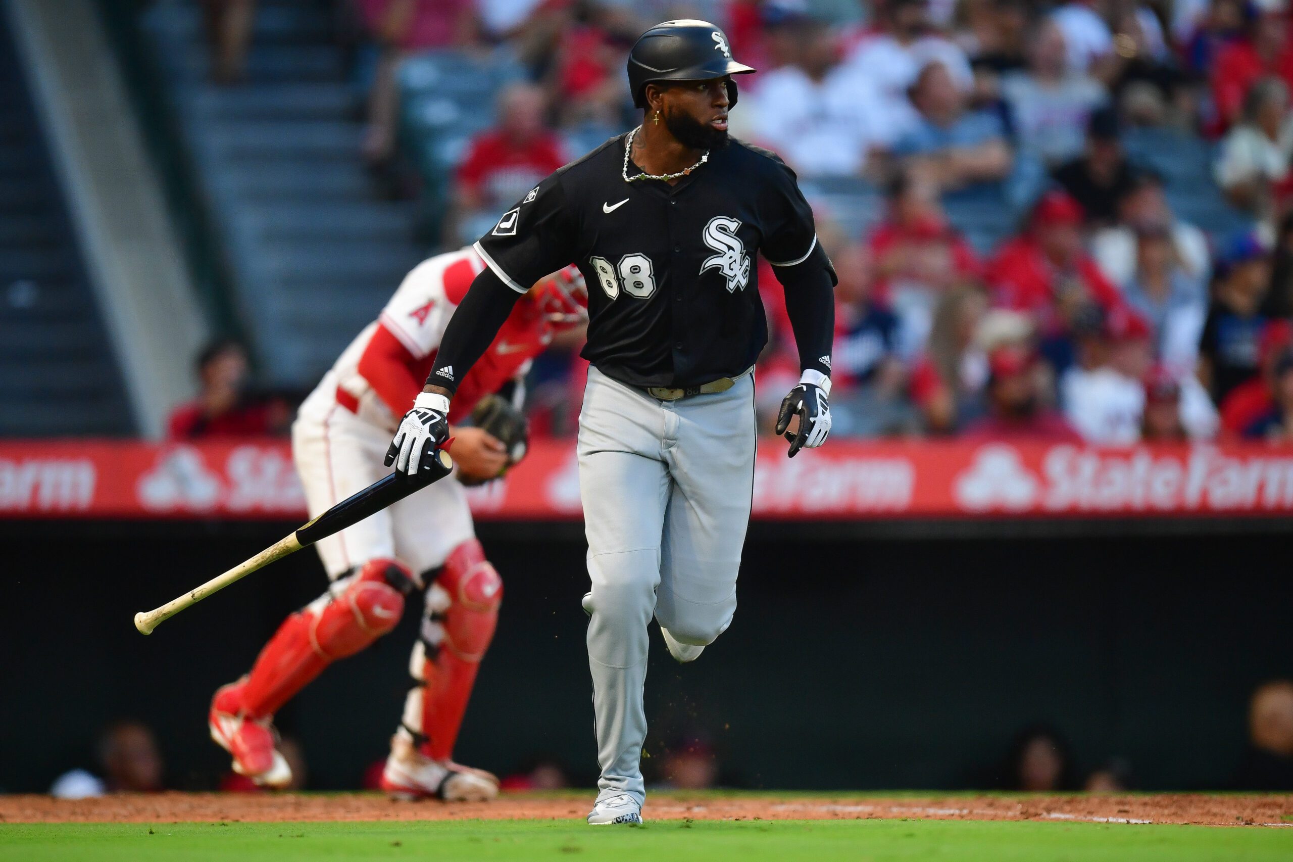 Aug 1, 2025; Anaheim, California, USA; Chicago White Sox center fielder Luis Robert Jr. (88) hits a sacrifice RBI against the Los Angeles Angels during the fourth inning at Angel Stadium. Mandatory Credit: Gary A. Vasquez-Imagn Images
