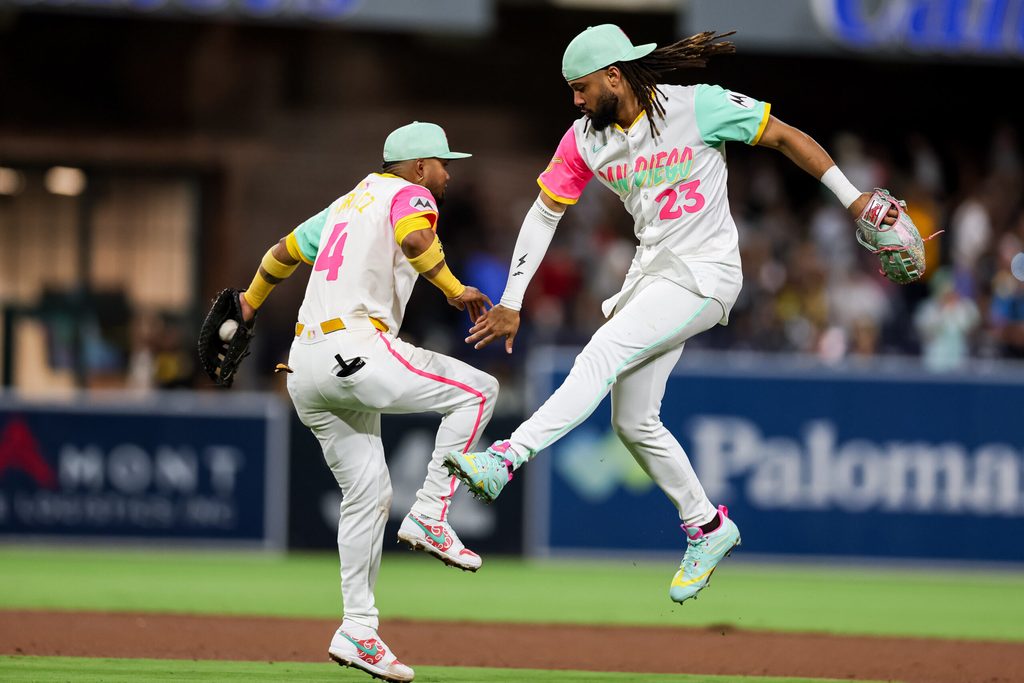 Aug 1, 2025; San Diego, California, USA; San Diego Padres right fielder Fernando Tatis Jr. (23) and first baseman Luis Arraez (4) high five after defeating the St. Louis Cardinals at Petco Park. Mandatory Credit: Chadd Cady-Imagn Images