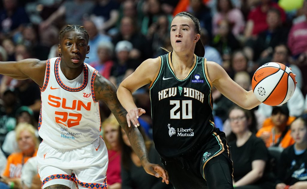 Aug 3, 2025; Uncasville, Connecticut, USA; New York Liberty guard Sabrina Ionescu (20) drives the ball against Connecticut Sun guard Saniya Rivers (22) in the second half at Mohegan Sun Arena. Mandatory Credit: David Butler II-Imagn Images