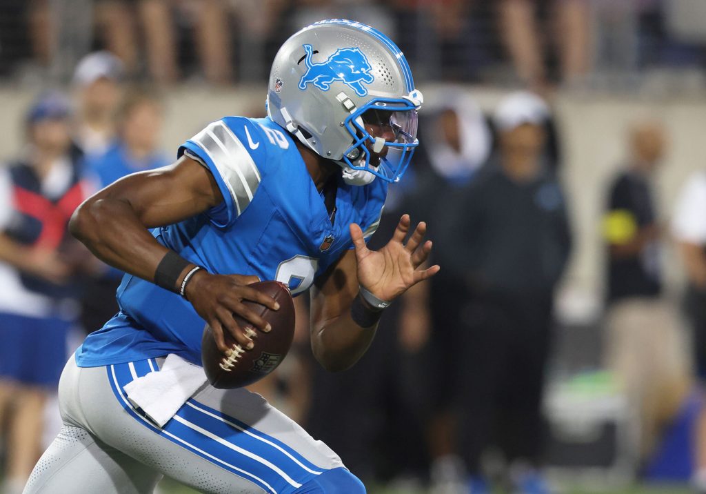 Jul 31, 2025; Canton, Ohio, USA; Detroit Lions quarterback Hendon Hooker (2) scrambles with the ball against the Los Angeles Chargers during the second half at Tom Benson Hall of Fame Stadium. Mandatory Credit: Charles LeClaire-Imagn Images