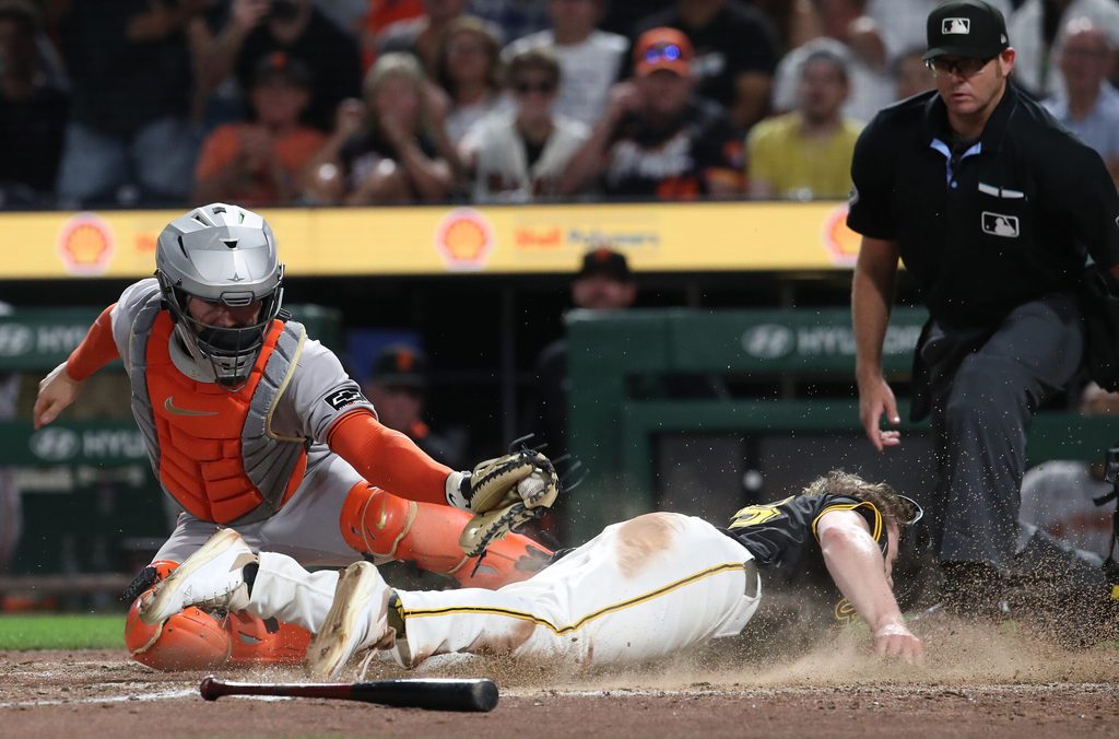 Aug 4, 2025; Pittsburgh, Pennsylvania, USA; Pittsburgh Pirates right fielder Jack Suwinski (right) slides past San Francisco Giants catcher Patrick Bailey (14) to score the game winning run during the ninth inning at PNC Park. Mandatory Credit: Charles LeClaire-Imagn Images