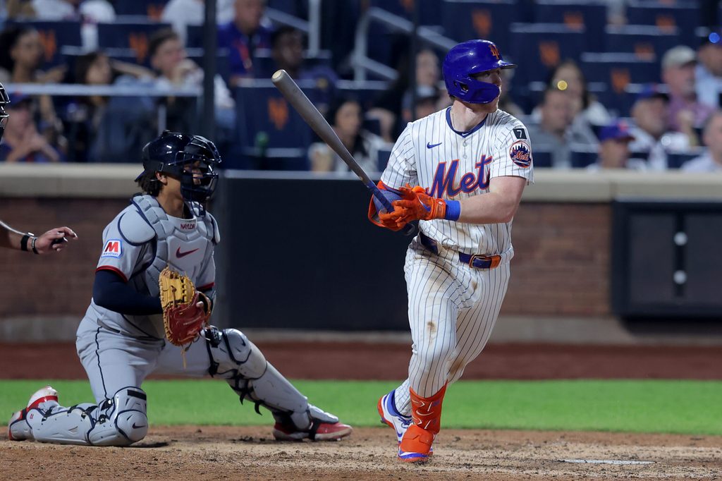 Aug 4, 2025; New York City, New York, USA; New York Mets third baseman Brett Baty (7) follows through on an RBI single against the Cleveland Guardians during the tenth inning at Citi Field. Mandatory Credit: Brad Penner-Imagn Images
