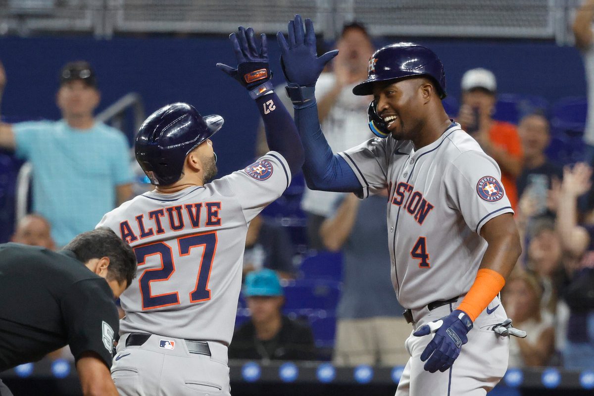 Aug 5, 2025; Miami, Florida, USA;  Houston Astros outfielder Jose Altuve (27) is greeted at the plate by outfielder Jesus Sanchez (4) after his two run home run against the Miami Marlins during the first inning at loanDepot Park. Mandatory Credit: Rhona Wise-Imagn Images