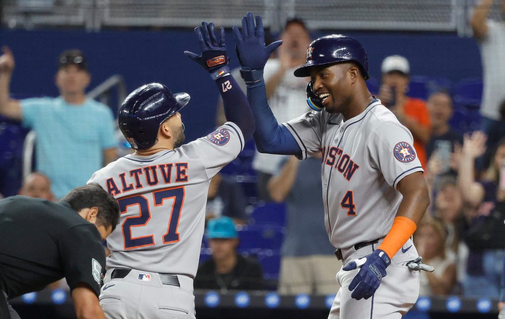 Aug 5, 2025; Miami, Florida, USA; Houston Astros outfielder Jose Altuve (27) is greeted at the plate by outfielder Jesus Sanchez (4) after his two run home run against the Miami Marlins during the first inning at loanDepot Park. Mandatory Credit: Rhona Wise-Imagn Images