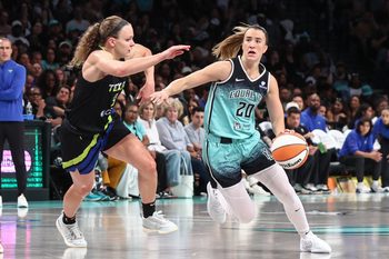 Aug 5, 2025; Brooklyn, New York, USA;  New York Liberty guard Sabrina Ionescu (20) looks to drive past Dallas Wings guard Grace Berger (9) in the third quarter at Barclays Center. Mandatory Credit: Wendell Cruz-Imagn Images