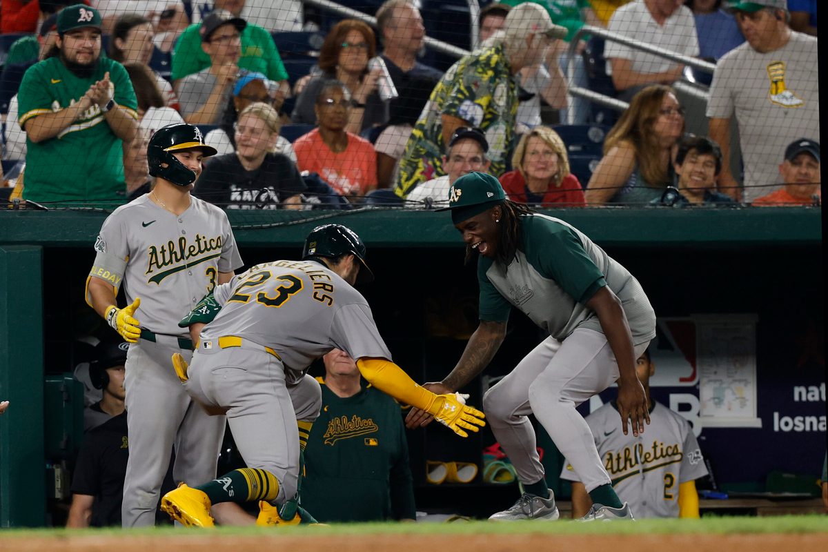 Aug 5, 2025; Washington, District of Columbia, USA; Athletics catcher Shea Langeliers (23) celebrates with teammates in the dugout after hitting a home run against the Washington Nationals during the seventh inning at Nationals Park. Mandatory Credit: Geoff Burke-Imagn Images