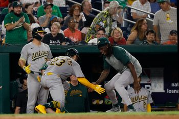 Aug 5, 2025; Washington, District of Columbia, USA; Athletics catcher Shea Langeliers (23) celebrates with teammates in the dugout after hitting a home run against the Washington Nationals during the seventh inning at Nationals Park. Mandatory Credit: Geoff Burke-Imagn Images