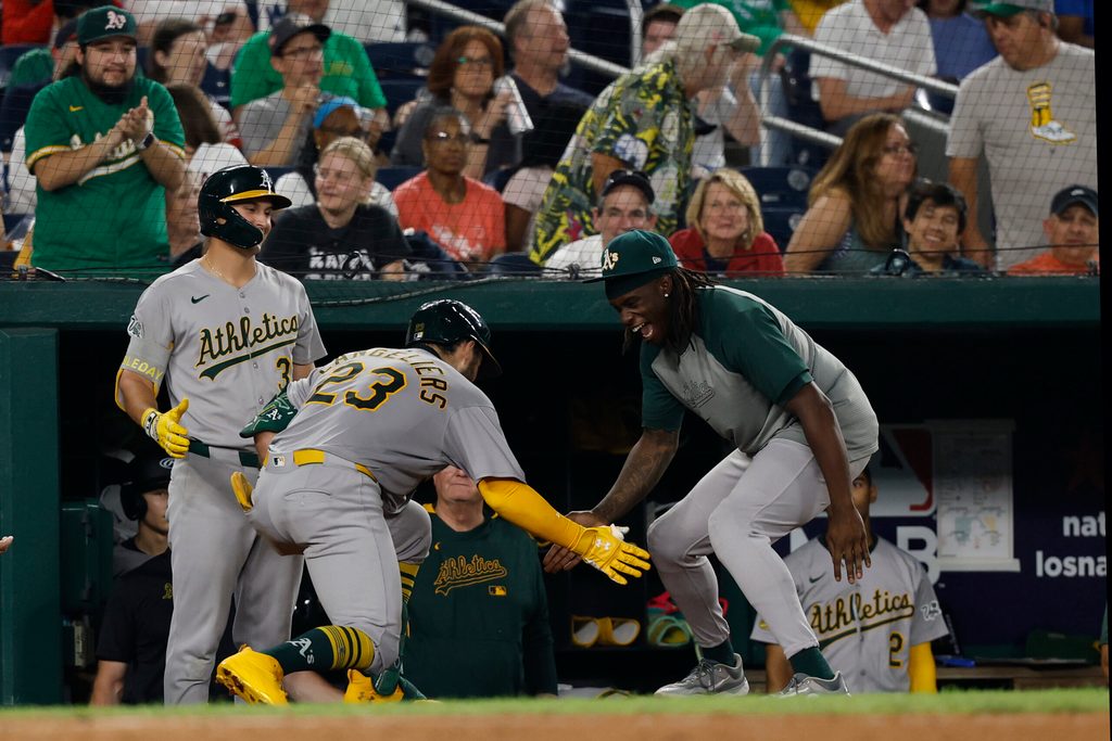 Aug 5, 2025; Washington, District of Columbia, USA; Athletics catcher Shea Langeliers (23) celebrates with teammates in the dugout after hitting a home run against the Washington Nationals during the seventh inning at Nationals Park. Mandatory Credit: Geoff Burke-Imagn Images