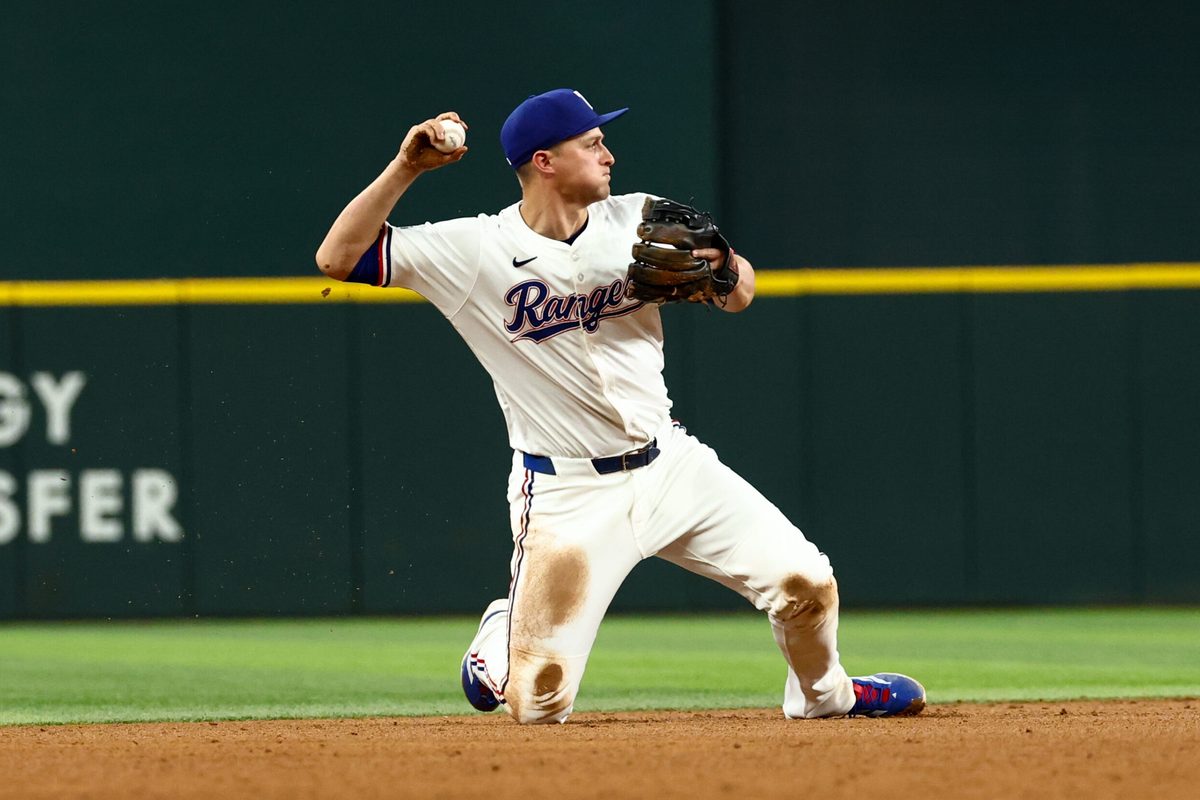 Aug 5, 2025; Arlington, Texas, USA; Texas Rangers shortstop Corey Seager (5) makes a diving stop to start a double play during the ninth inning against the New York Yankees at Globe Life Field. Mandatory Credit: Kevin Jairaj-Imagn Images