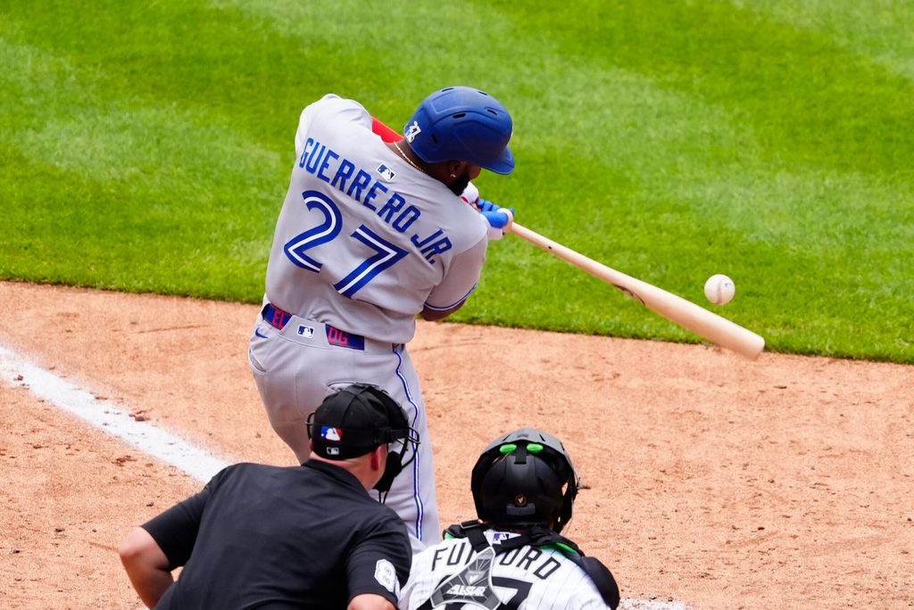 Aug 6, 2025; Denver, Colorado, USA; Toronto Blue Jays first base Vladimir Guerrero Jr. (27) doubles in the ninth inning against the Colorado Rockies at Coors Field. Mandatory Credit: Ron Chenoy-Imagn Images