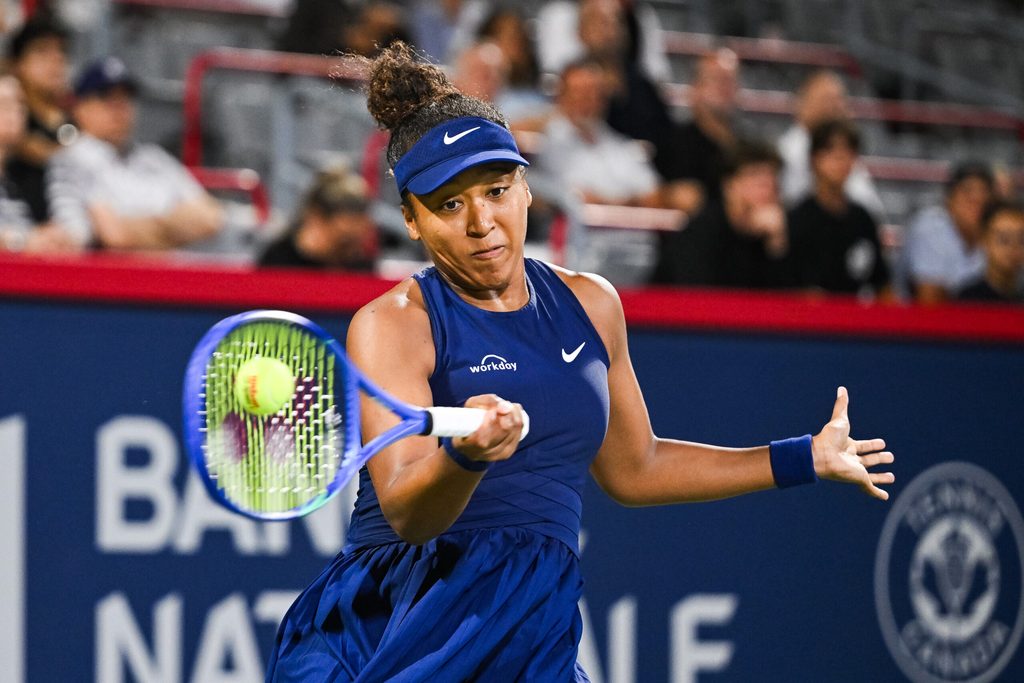 Aug 6, 2025; Montreal, QC, Canada; Naomi Osaka (JPN) returns the ball to Clara Tauson (DEN) in semifinal play at IGA Stadium. Mandatory Credit: David Kirouac-Imagn Images