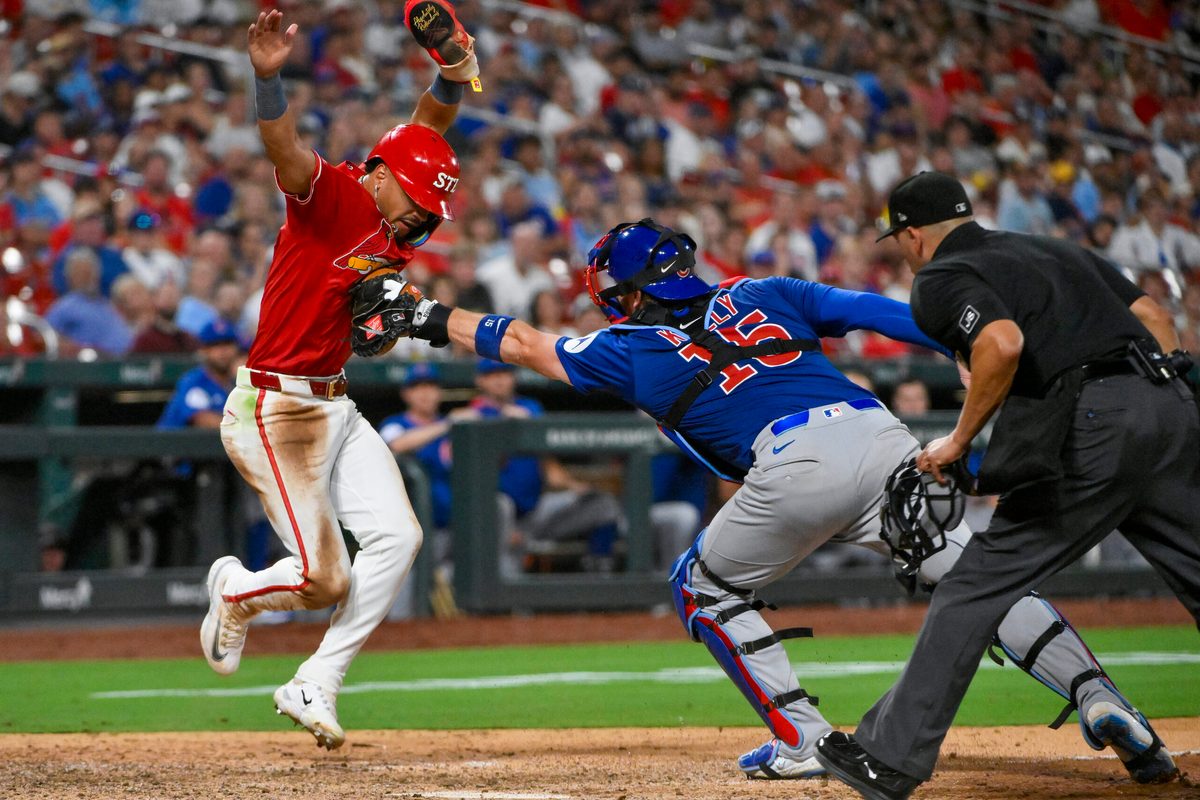 Aug 8, 2025; St. Louis, Missouri, USA; St. Louis Cardinals shortstop Masyn Winn (0) is tagged out by Chicago Cubs catcher Carson Kelly (15) during the eighth inning at Busch Stadium. Mandatory Credit: Jeff Curry-Imagn Images