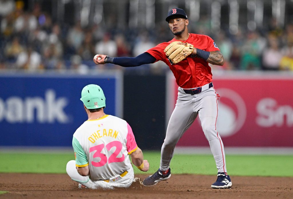 Aug 8, 2025; San Diego, California, USA; Boston Red Sox center fielder Ceddanne Rafaela (3) throws over San Diego Padres first baseman Ryan O'Hearn (32) as he tries to turn a double play during the eighth inning at Petco Park. Mandatory Credit: Denis Poroy-Imagn Images
