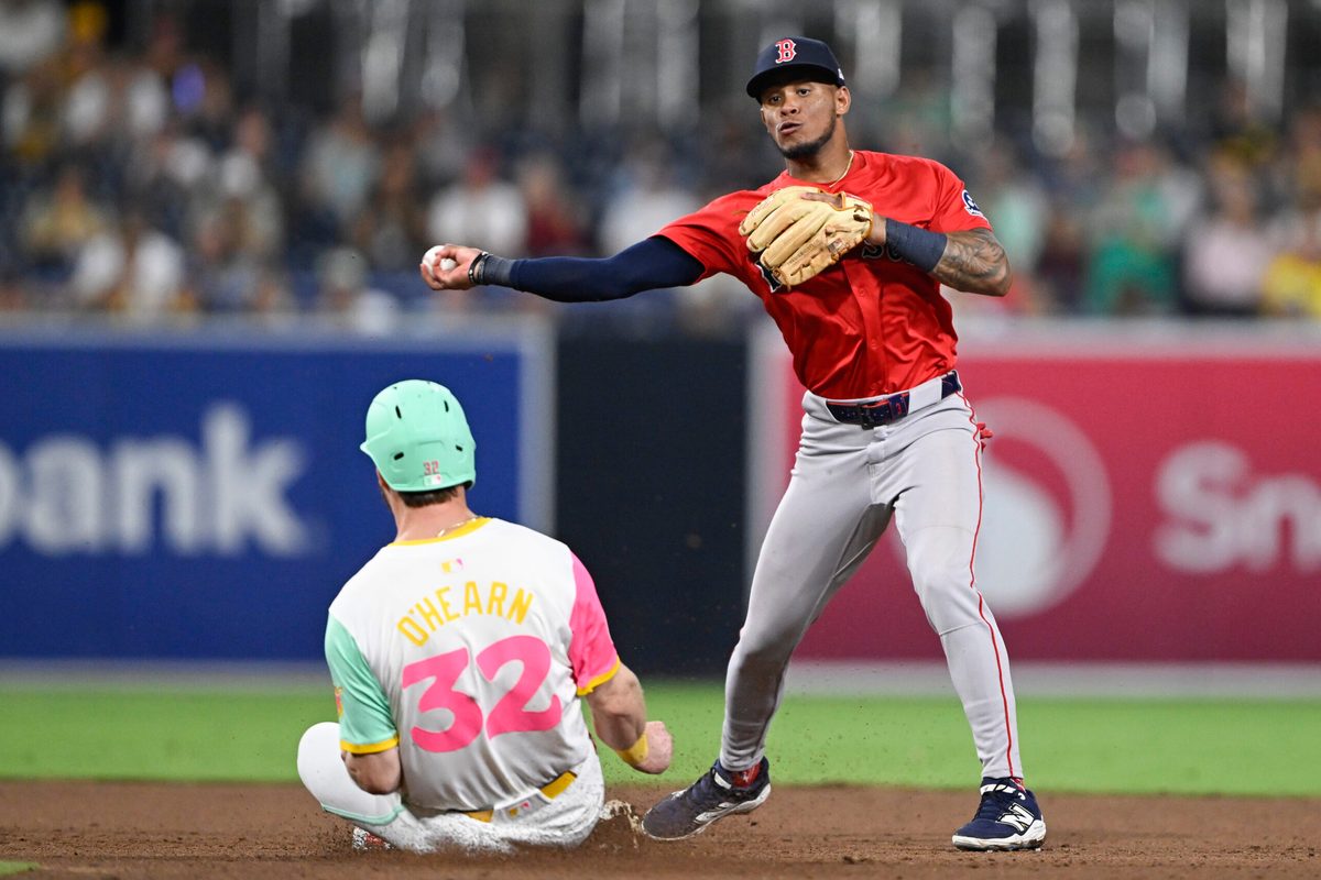 Aug 8, 2025; San Diego, California, USA; Boston Red Sox center fielder Ceddanne Rafaela (3) throws over San Diego Padres first baseman Ryan O'Hearn (32) as he tries to turn a double play during the eighth inning at Petco Park. Mandatory Credit: Denis Poroy-Imagn Images
