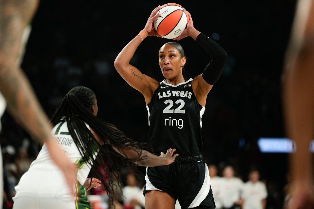 Aug 8, 2025; Las Vegas, Nevada, USA; Las Vegas Aces center A'ja Wilson (22) controls the ball against Seattle Storm forward Ezi Magbegor (13) during the first half of a WNBA basketball game at Michelob Ultra Arena. Mandatory Credit: Lucas Peltier-Imagn Images