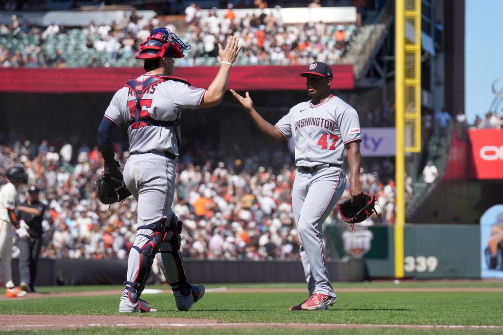 Aug 9, 2025; San Francisco, California, USA; Washington Nationals pitcher Jose Ferrer (47) and catcher Riley Adams (15) meet after recording the last out of the game against the San Francisco Giants at Oracle Park. Mandatory Credit: Cary Edmondson-Imagn Images