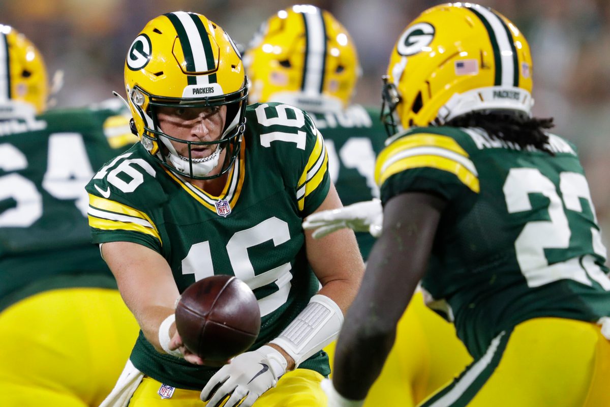 Aug 9, 2025; Green Bay, Wisconsin, USA; Green Bay Packers quarterback Sean Clifford (16) hands off the ball to running back Israel Abanikanda (23) against the New York Jets during the second half at Lambeau Field. Mandatory Credit: Dan Powers/USA TODAY NETWORK-Wisconsin/Imagn Images