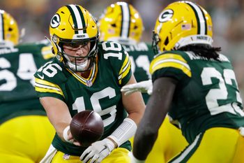 Aug 9, 2025; Green Bay, Wisconsin, USA; Green Bay Packers quarterback Sean Clifford (16) hands off the ball to running back Israel Abanikanda (23) against the New York Jets during the second half at Lambeau Field. Mandatory Credit: Dan Powers/USA TODAY NETWORK-Wisconsin/Imagn Images