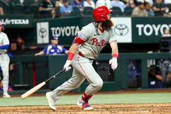 Aug 10, 2025; Arlington, Texas, USA; Philadelphia Phillies center fielder Brandon Marsh (16) hits an rbi sacrifice fly  during the ninth inning against the Texas Rangers at Globe Life Field. Mandatory Credit: Kevin Jairaj-Imagn Images