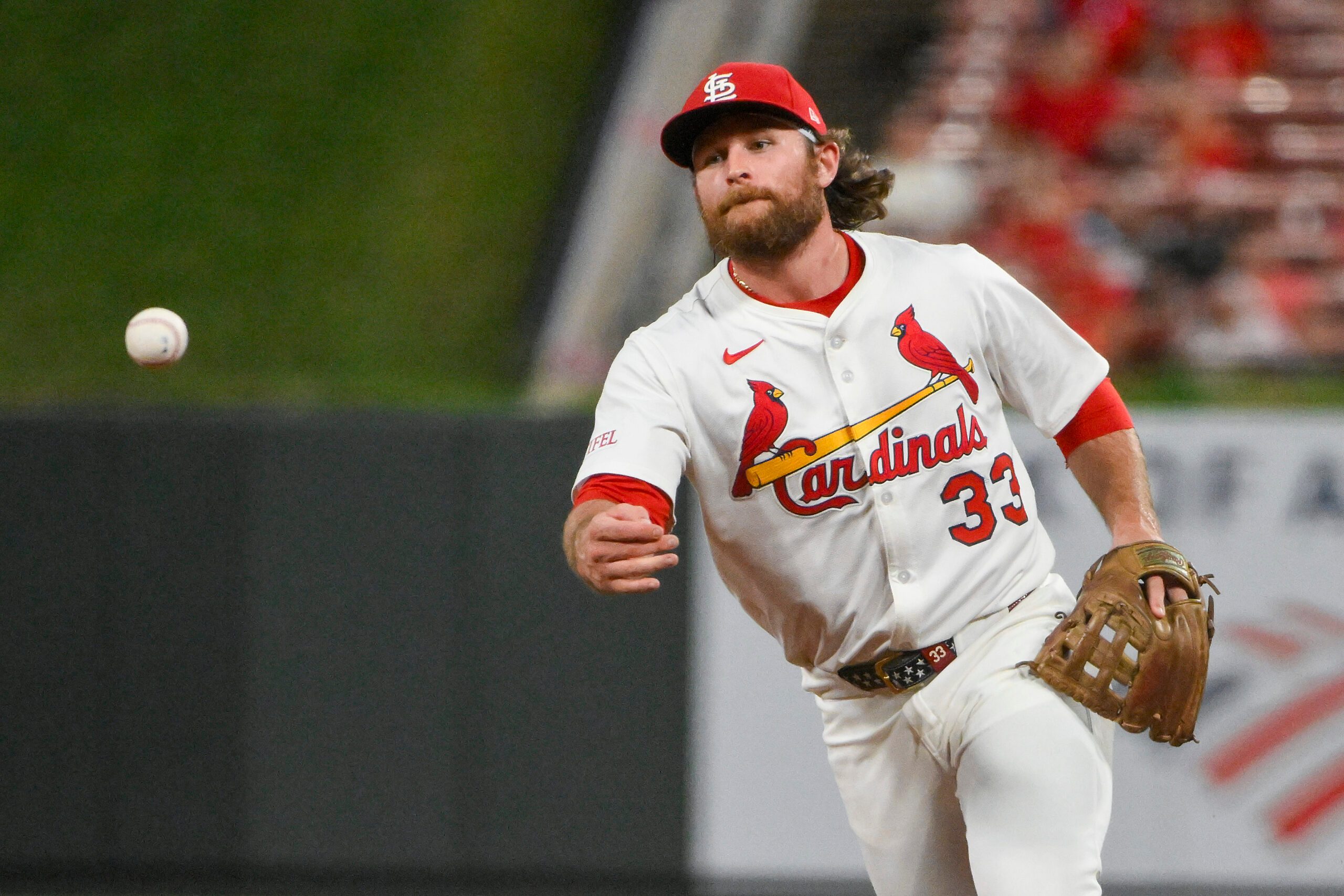 Aug 11, 2025; St. Louis, Missouri, USA;  St. Louis Cardinals second baseman Brendan Donovan (33) flips the ball to first base during the ninth inning against the Colorado Rockies at Busch Stadium. Mandatory Credit: Jeff Curry-Imagn Images