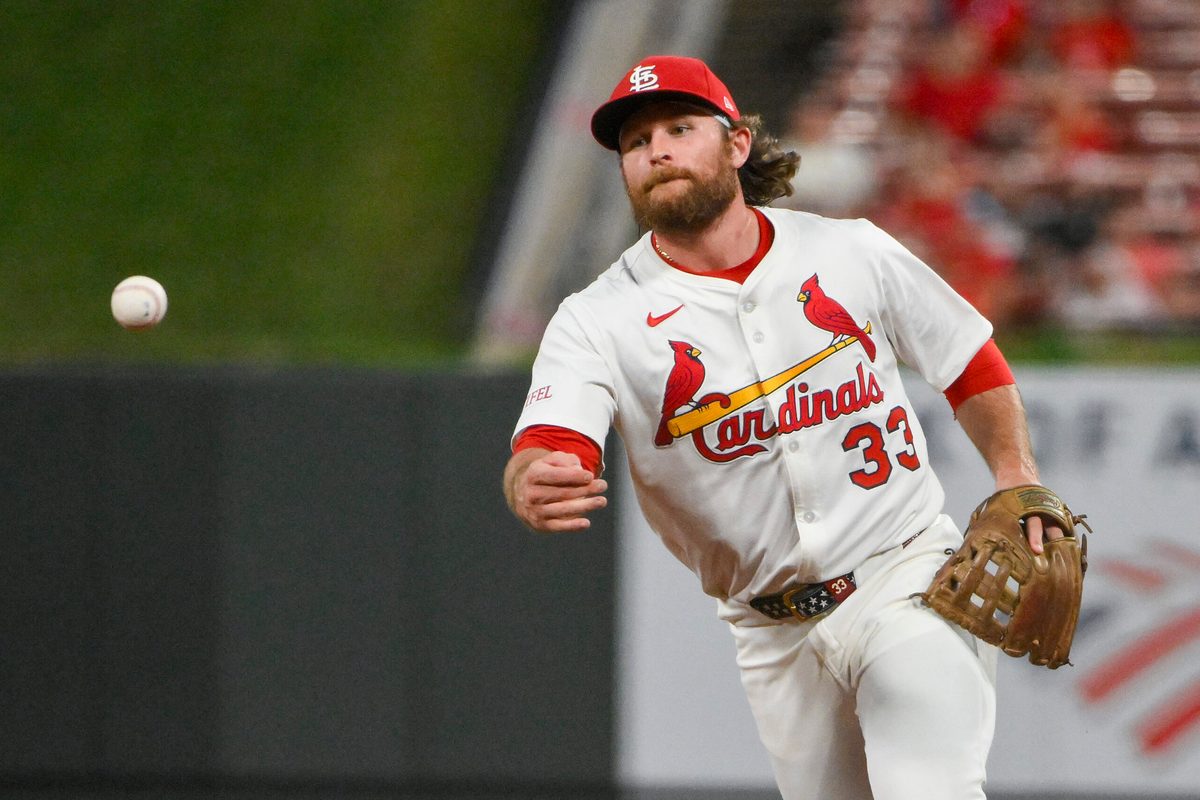 Aug 11, 2025; St. Louis, Missouri, USA; St. Louis Cardinals second baseman Brendan Donovan (33) flips the ball to first base during the ninth inning against the Colorado Rockies at Busch Stadium. Mandatory Credit: Jeff Curry-Imagn Images