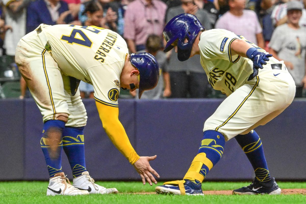 Aug 12, 2025; Milwaukee, Wisconsin, USA; Milwaukee Brewers first baseman Andrew Vaughn (28) celebrates with catcher William Contreras (24) after hitting a three run home run in the sixth inning at American Family Field. Mandatory Credit: Benny Sieu-Imagn Images