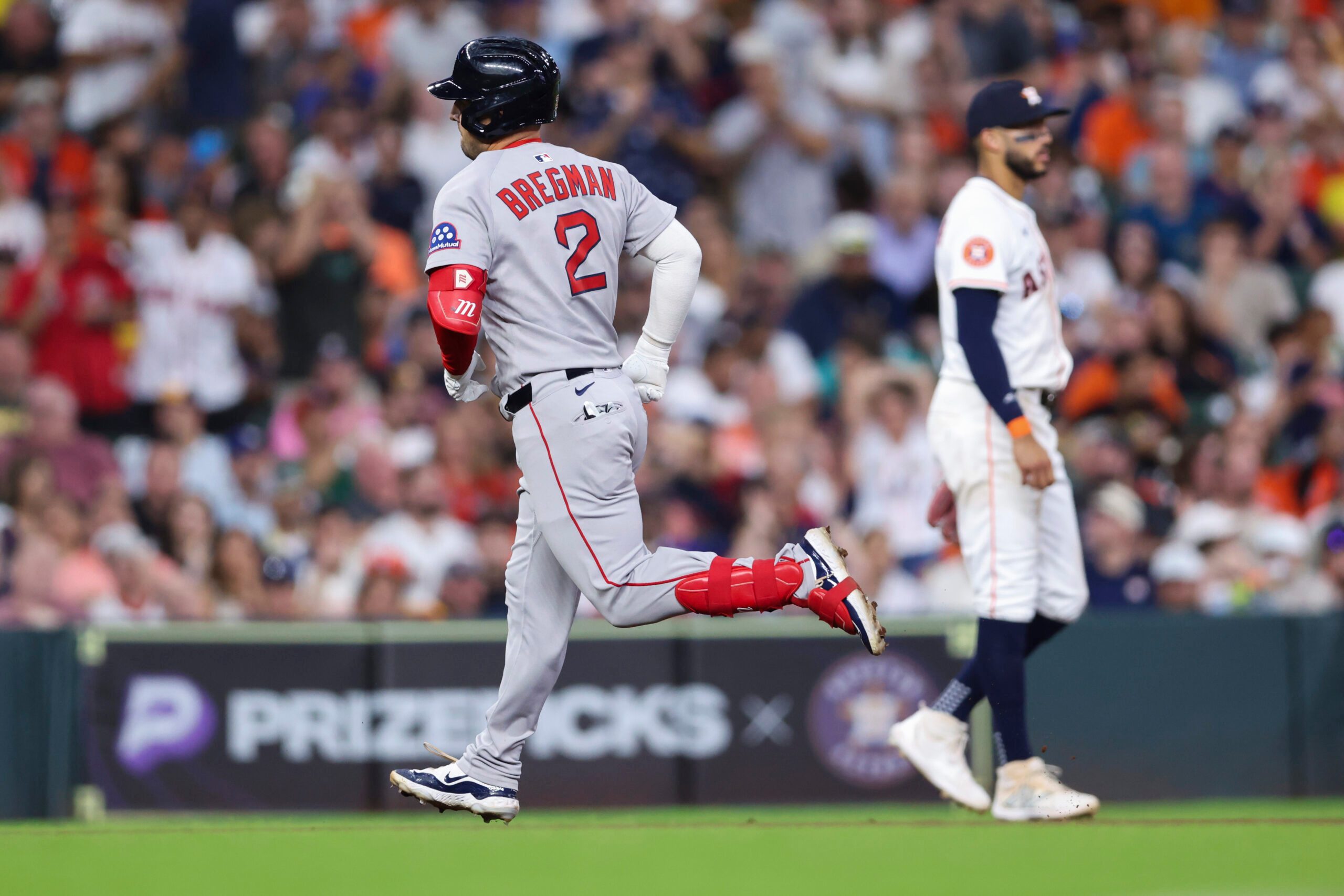 Aug 12, 2025; Houston, Texas, USA; Houston Astros third baseman Carlos Correa (1) reacts as Boston Red Sox third baseman Alex Bregman (2) rounds the bases after hitting a home run during the sixth inning at Daikin Park. Mandatory Credit: Troy Taormina-Imagn Images