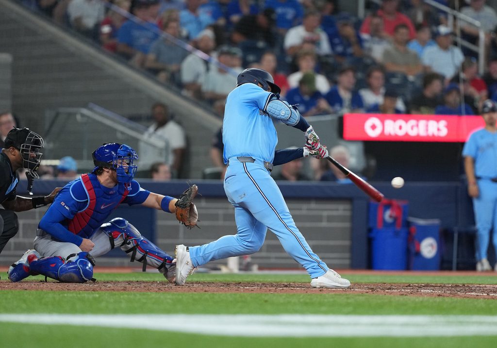 Aug 12, 2025; Toronto, Ontario, CAN; Toronto Blue Jays centre fielder Daulton Varsho (5) hits a home run against the Chicago Cubs during the eighth inning at Rogers Centre. Mandatory Credit: Nick Turchiaro-Imagn Images