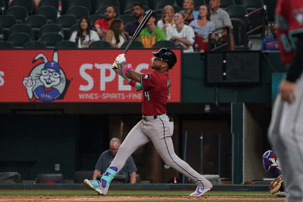 Aug 13, 2025; Arlington, Texas, USA; Arizona Diamondbacks second baseman Ketel Marte (4) follows through on a three-run home run during the ninth inning against the Texas Rangers at Globe Life Field. Mandatory Credit: Raymond Carlin III-Imagn Images