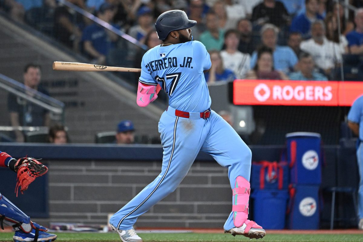 Aug 13, 2025; Toronto, Ontario, CAN; Toronto Blue Jays first baseman Vladimir Guerrero Jr. (27) hits an RBI double against the Chicago Cubs in the sixth inning at Rogers Centre. Mandatory Credit: Dan Hamilton-Imagn Images