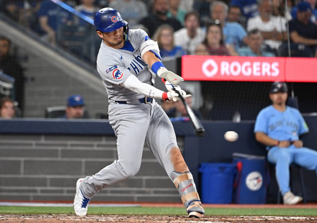 Aug 13, 2025; Toronto, Ontario, CAN; Chicago Cubs designated hitter Seiya Suzuki (27) hits an RBI single against the Toronto Blue Jays in the eighth inning at Rogers Centre. Mandatory Credit: Dan Hamilton-Imagn Images